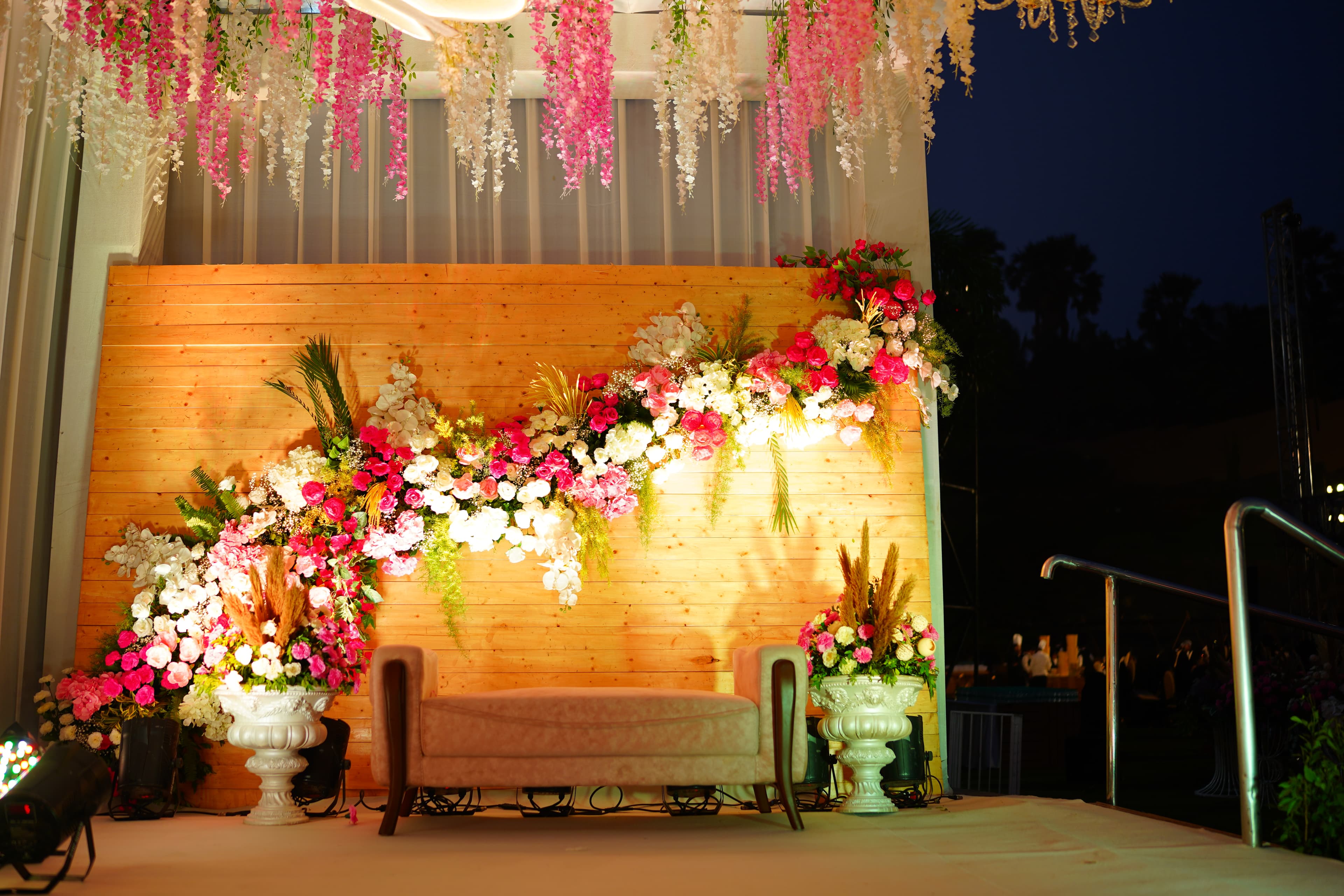 Rustic wooden backdrop with floral garland and settee